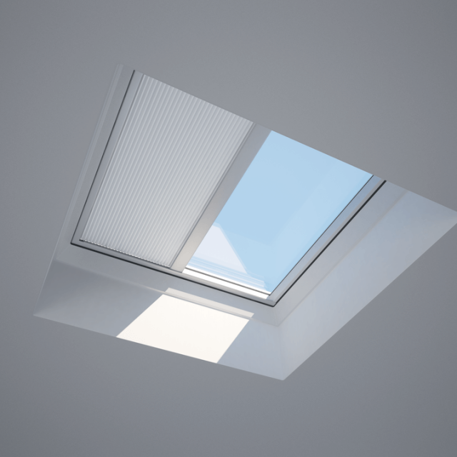 a flat roof window with a blind